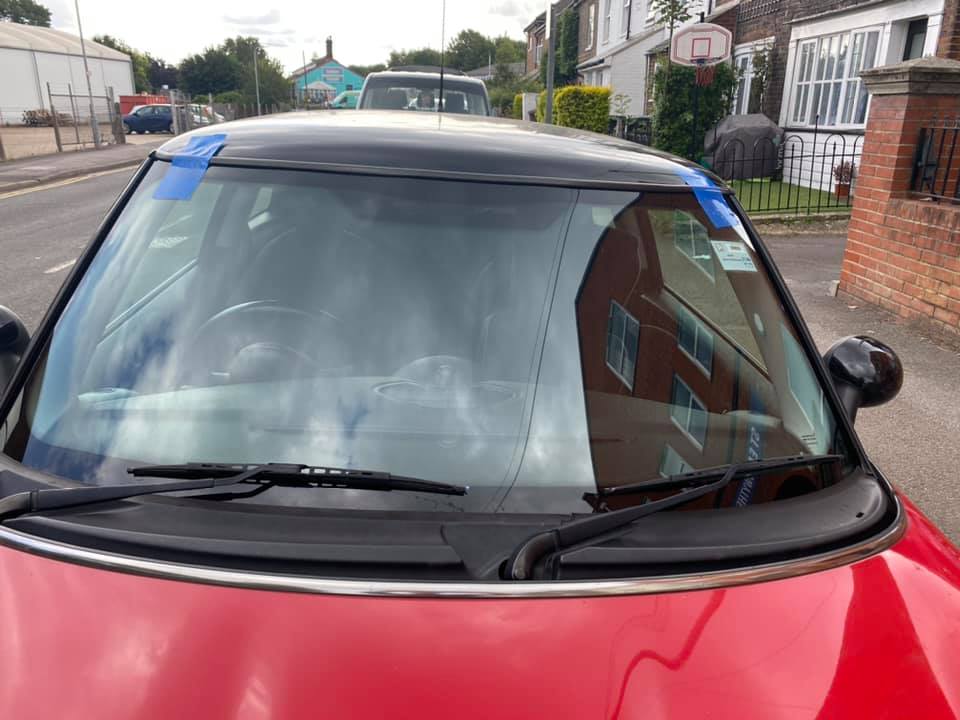 a red Mini Cooper with a brand new windscreen in dover