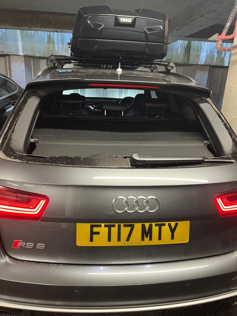 back of a grey Audi with a windscreen being replaced